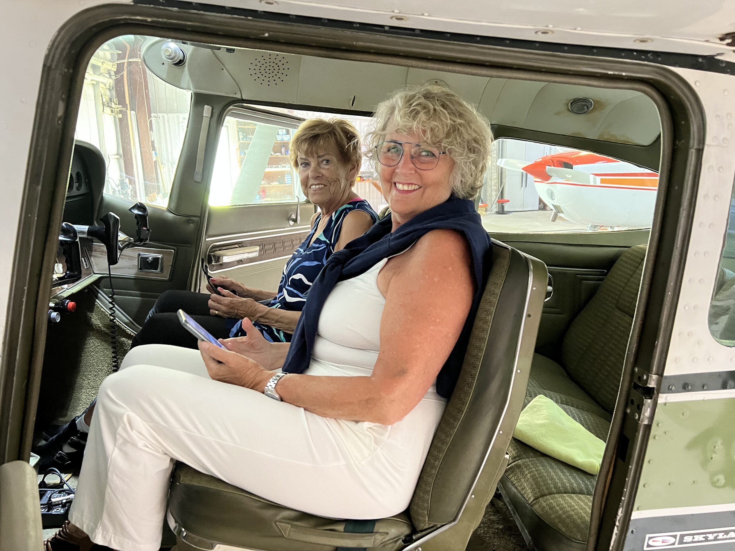 Passengers seated inside a small airplane preparing for a flight lesson