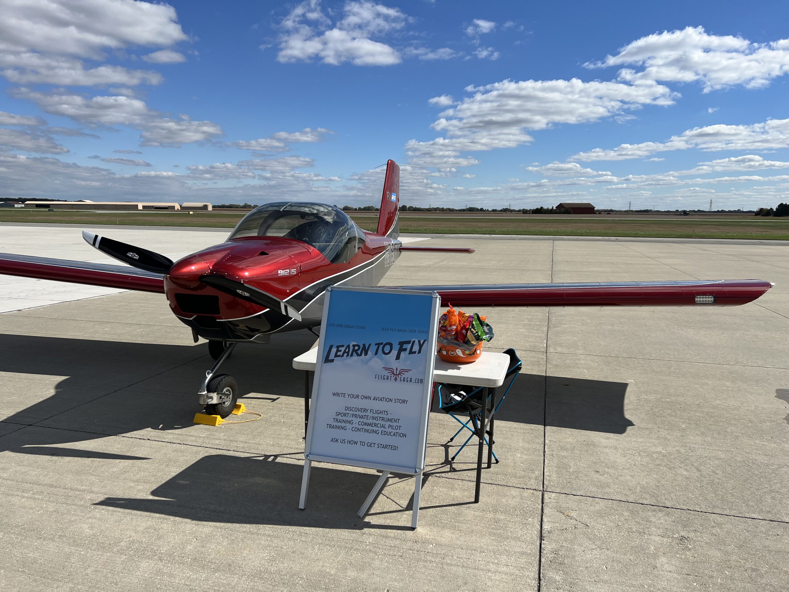 Red and gray training aircraft with a Learn to Fly sign at a Northwest Indiana airport