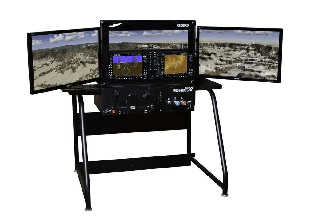 Redbird flight simulator with triple-monitor display used for pilot training